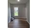 Inviting living room featuring new hardwood flooring, staircase, and a bright window at 1501 California St, Columbus, IN 47201