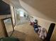 Attic space with carpet and sloped ceilings converted into play area at 1510 Chester St, Anderson, IN 46012