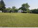 Expansive green yard features a home with a chimney and mature trees at 1510 Chester St, Anderson, IN 46012