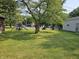 Large backyard featuring a storage building and playset at 1510 Chester St, Anderson, IN 46012