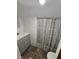 Small bathroom with white sink vanity and decorative shower curtain at 1510 Chester St, Anderson, IN 46012