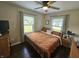 Comfortable bedroom with hardwood floors, fan, windows, and a metal frame bed at 1510 Chester St, Anderson, IN 46012