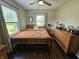 Bedroom features natural light, ceiling fan, wood floors, and metal frame bed at 1510 Chester St, Anderson, IN 46012