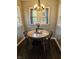 Cozy dining area featuring a round table with modern chandelier lighting and a view to the outdoors at 1510 Chester St, Anderson, IN 46012