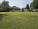 A grassy yard with scattered trees surrounding the house at 1510 Chester St, Anderson, IN 46012