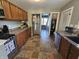 This kitchen has stainless steel appliances, wooden cabinets and easy access to stairs at 1510 Chester St, Anderson, IN 46012
