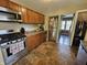 This kitchen has stainless steel appliances and wooden cabinets with backyard views at 1510 Chester St, Anderson, IN 46012