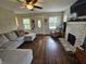 Bright living room has hardwood floors, brick fireplace and plenty of light at 1510 Chester St, Anderson, IN 46012