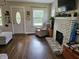 Comfortable living room features a white brick fireplace and hardwood floors at 1510 Chester St, Anderson, IN 46012