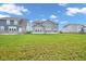 Large backyard with lush green grass and a view of the home's exterior with large windows at 15359 Manning Way, Westfield, IN 46074