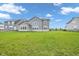 Expansive backyard featuring a well-maintained lawn and the rear exterior of a gray two-story home at 15359 Manning Way, Westfield, IN 46074