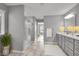 A bathroom with a glass shower, gray vanity, and bright light, showing the neutral interior design at 15359 Manning Way, Westfield, IN 46074