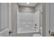 Bright bathroom features a shower-tub combination with white tile surround at 15359 Manning Way, Westfield, IN 46074