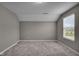 Cozy bedroom featuring plush carpeting, neutral paint, and bright, natural light from the window at 15359 Manning Way, Westfield, IN 46074