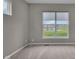 Bright bedroom with large window showcasing a neighborhood and community pond at 15359 Manning Way, Westfield, IN 46074