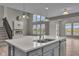 Modern kitchen featuring a spacious island, stainless steel appliances, and a decorative fireplace at 15359 Manning Way, Westfield, IN 46074