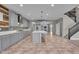Open-concept kitchen with an island, stairs, and modern finishes at 15359 Manning Way, Westfield, IN 46074