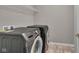 Laundry room featuring modern Samsung washer and dryer set, plus storage space and neutral walls at 15359 Manning Way, Westfield, IN 46074