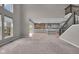 Open floor plan with living room leading to modern kitchen, enhanced by staircase with dark wooden handrail at 15359 Manning Way, Westfield, IN 46074