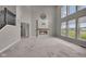 Spacious living room features a modern fireplace, plush carpet, and large windows with natural light at 15359 Manning Way, Westfield, IN 46074