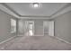 Spacious main bedroom with tray ceiling, neutral carpet, and multiple doorways, creating an open layout at 15359 Manning Way, Westfield, IN 46074