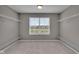 Empty walk-in closet features built-in shelving, neutral carpet, and a bright window, creating an organized space at 15359 Manning Way, Westfield, IN 46074