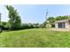 Large backyard featuring a spacious lawn area and a storage shed at 1543 W 79Th St, Indianapolis, IN 46260