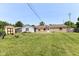 Spacious backyard with green lawn and a shed adjacent to the house at 1543 W 79Th St, Indianapolis, IN 46260