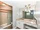 Well lit bathroom with a sink with marble top and a shower stall with a glass door at 1543 W 79Th St, Indianapolis, IN 46260
