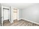 Bedroom with hardwood floors and sliding door closet with a door to another room at 1543 W 79Th St, Indianapolis, IN 46260