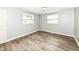 Bedroom with two windows with blinds and hardwood floors at 1543 W 79Th St, Indianapolis, IN 46260