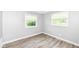 Bedroom with hardwood floors and two windows with blinds at 1543 W 79Th St, Indianapolis, IN 46260