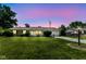 Exterior view of a cozy home during dusk, featuring a well-kept lawn and inviting curb appeal at 1543 W 79Th St, Indianapolis, IN 46260