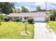 Charming single-story home with a brick facade, well-maintained lawn, and attached two car garage at 1543 W 79Th St, Indianapolis, IN 46260