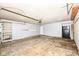 Spacious garage with an overhead door, shelving, and a refrigerator at 1543 W 79Th St, Indianapolis, IN 46260