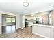 Open-concept kitchen featuring stainless appliances, white cabinets, and easy access to the living area at 1543 W 79Th St, Indianapolis, IN 46260