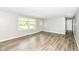 Inviting living room with stylish flooring, light walls, a bright window, and welcoming front door at 1543 W 79Th St, Indianapolis, IN 46260