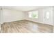 Bright, open living room with hardwood floors, large windows, and a freshly painted interior at 1543 W 79Th St, Indianapolis, IN 46260