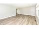 View of a sunny living room with modern flooring, neutral walls, and easy access to other living spaces at 1543 W 79Th St, Indianapolis, IN 46260