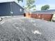Gravel backyard area with a privacy fence and a detached garage at 1628 Spann Ave, Indianapolis, IN 46203