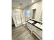 Bathroom featuring double vanity sinks, a toilet, and shower with glass doors at 1628 Spann Ave, Indianapolis, IN 46203