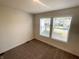 Bedroom with neutral carpet and two windows providing natural light at 1628 Spann Ave, Indianapolis, IN 46203
