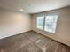 Cozy bedroom with neutral carpet and two windows offering natural light at 1628 Spann Ave, Indianapolis, IN 46203
