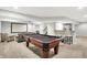 Basement featuring a pool table, wet bar, and ample seating area for recreation and entertainment at 1808 Woodfield Dr, Greenwood, IN 46143