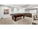 Finished basement boasts a pool table, recessed lighting, and media area perfect for entertaining at 1808 Woodfield Dr, Greenwood, IN 46143