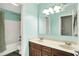Bathroom featuring double sinks, wood cabinets, and a shower-tub combo at 1808 Woodfield Dr, Greenwood, IN 46143