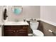 Cozy bathroom featuring vanity with stylish fixtures and a toilet with decorative basket at 1808 Woodfield Dr, Greenwood, IN 46143