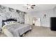 This bedroom includes decorative wall coverings and a ceiling fan for added comfort at 1808 Woodfield Dr, Greenwood, IN 46143