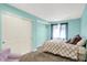 This bedroom features soothing blue walls, cozy carpet, and a closet for storage solutions at 1808 Woodfield Dr, Greenwood, IN 46143