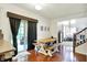 Bright dining area boasts hardwood floors and direct access to a kitchen and living room at 1808 Woodfield Dr, Greenwood, IN 46143